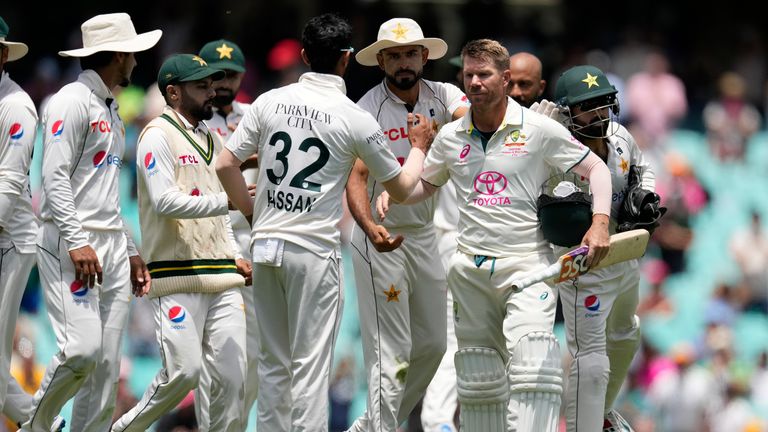 Australia's David Warner, third right, is congratulated by Pakistan's players as he walks off the field on the fourth day of their cricket test match in Sydney