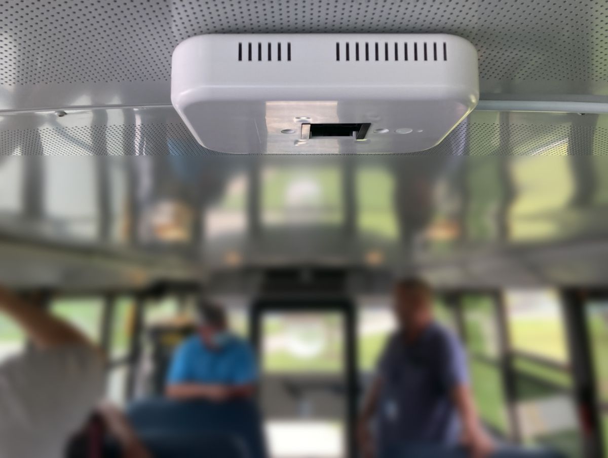 A white UV lamp on the top of a school bus