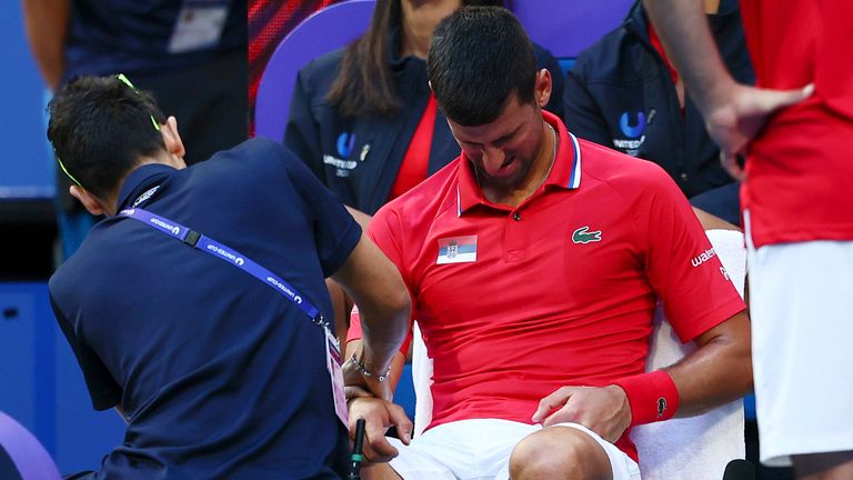 Novak Djokovic receives treatment on a wrist injury