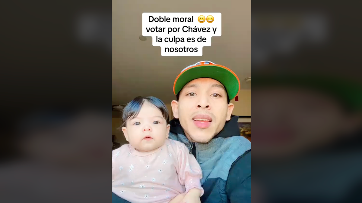 Man speaking to camera with baby