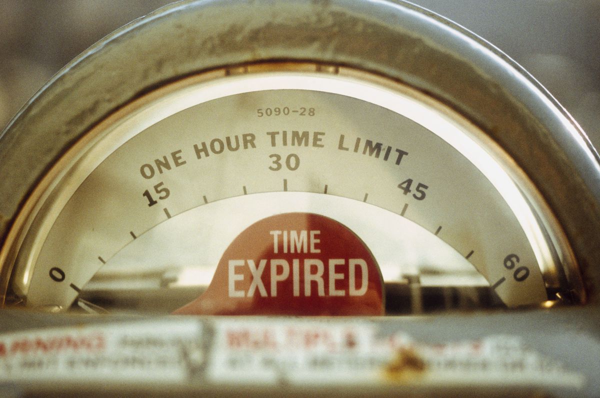 A parking meter with a one-hour time limit and its red flag that reads “time expired.”