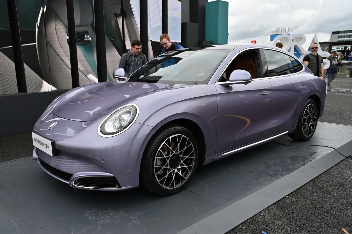 A sleek silver-purple car parked outside. 