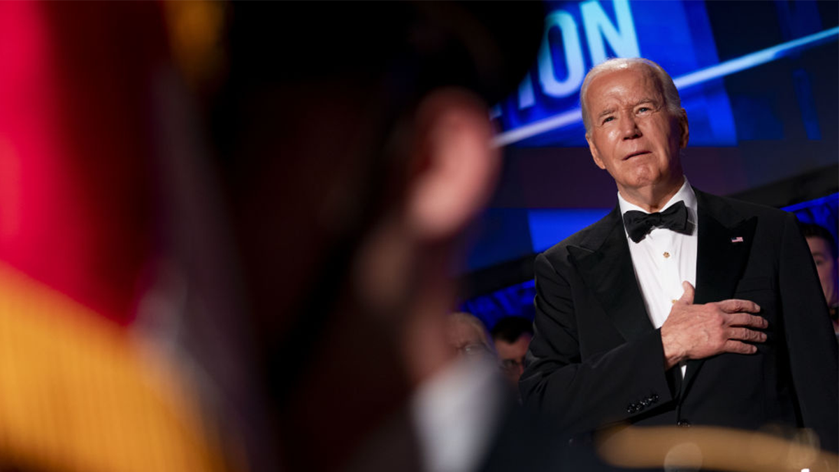 President Joe Biden stands for the pledge of allegiance during the White House Correspondents' Association (WHCA) dinner in Washington, D.C.