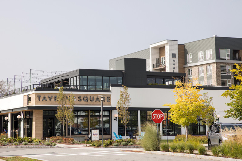 A modular mall store seen from across an intersection reads “Tavern Square.”
