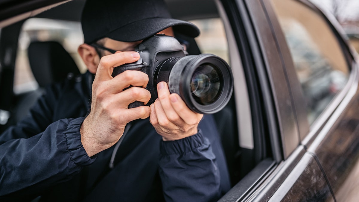 man taking picture in car