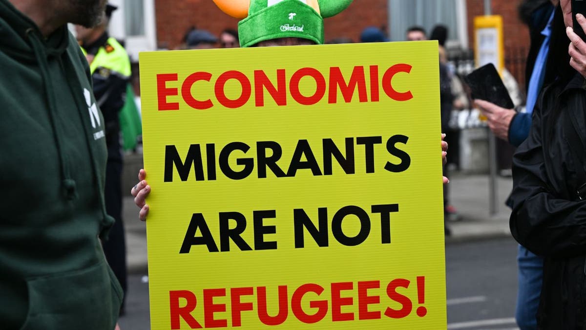 A sign reading: "Economic migrants are not refugees"