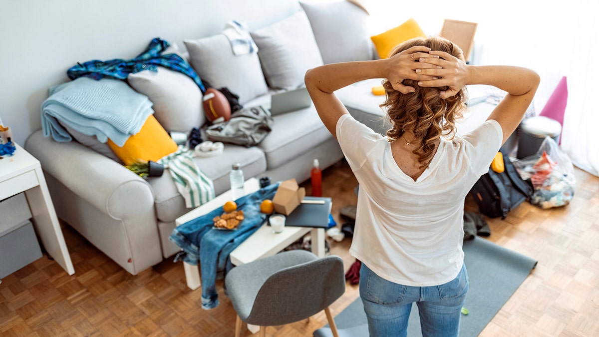 woman looking overwhelmed at mess