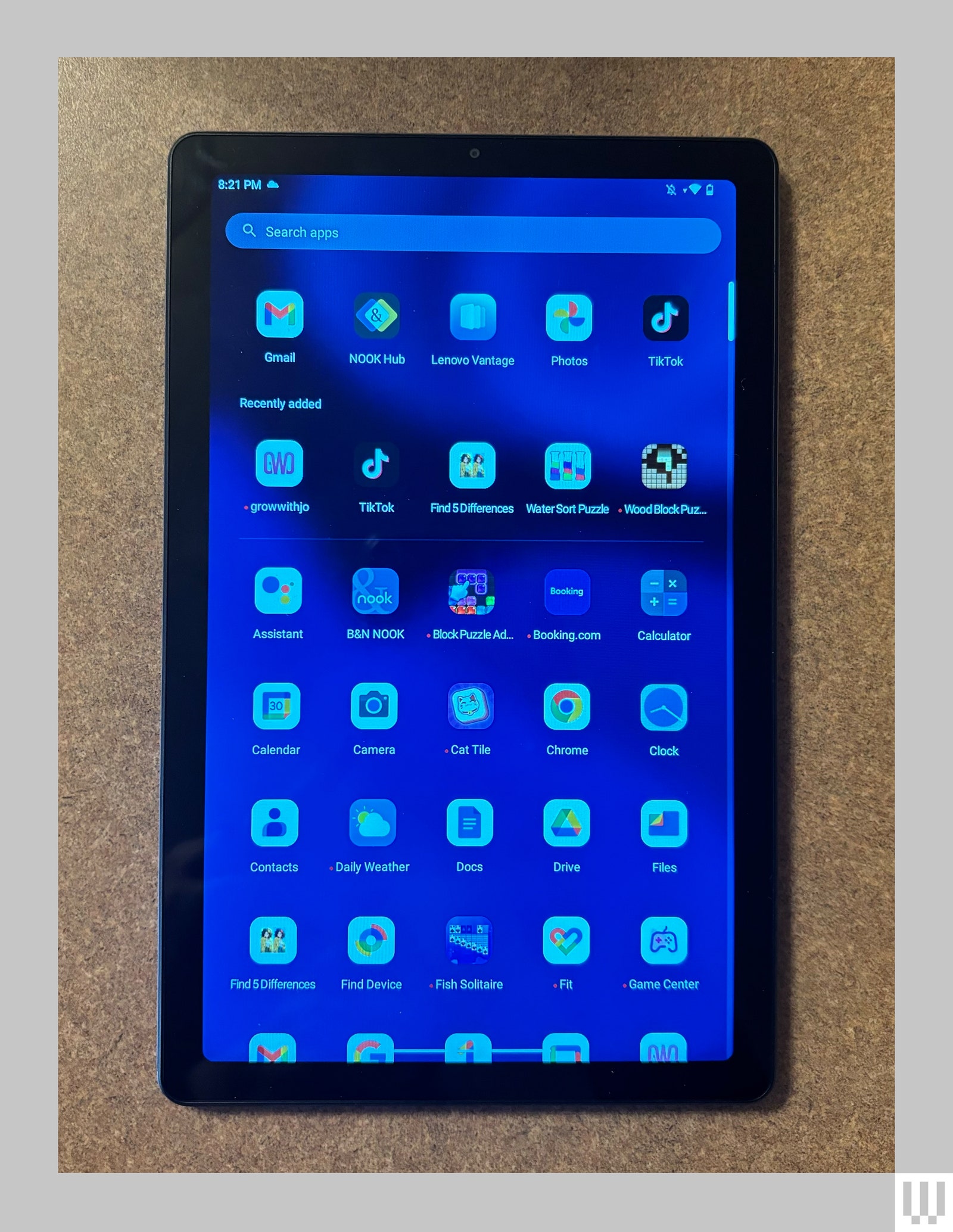 Tablet screen showing various app icons and a search bar