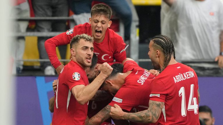 Turkey's Mert Muldur celebrates with team mates after scoring his side's opening goal during a Group F match between Turkey and Georgia at the Euro 2024 soccer tournament in Dortmund, Germany, Tuesday, June 18, 2024. (AP Photo/Martin Meissner)