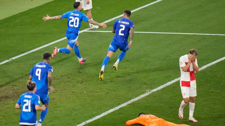 Italy's Mattia Zaccagni, top left, celebrates after he scored his side's opening goal during the Group B match between Croatia and Italy at the Euro 2024 soccer tournament in Leipzig, Germany, Monday, June 24, 2024. (AP Photo/Sergei Grits)