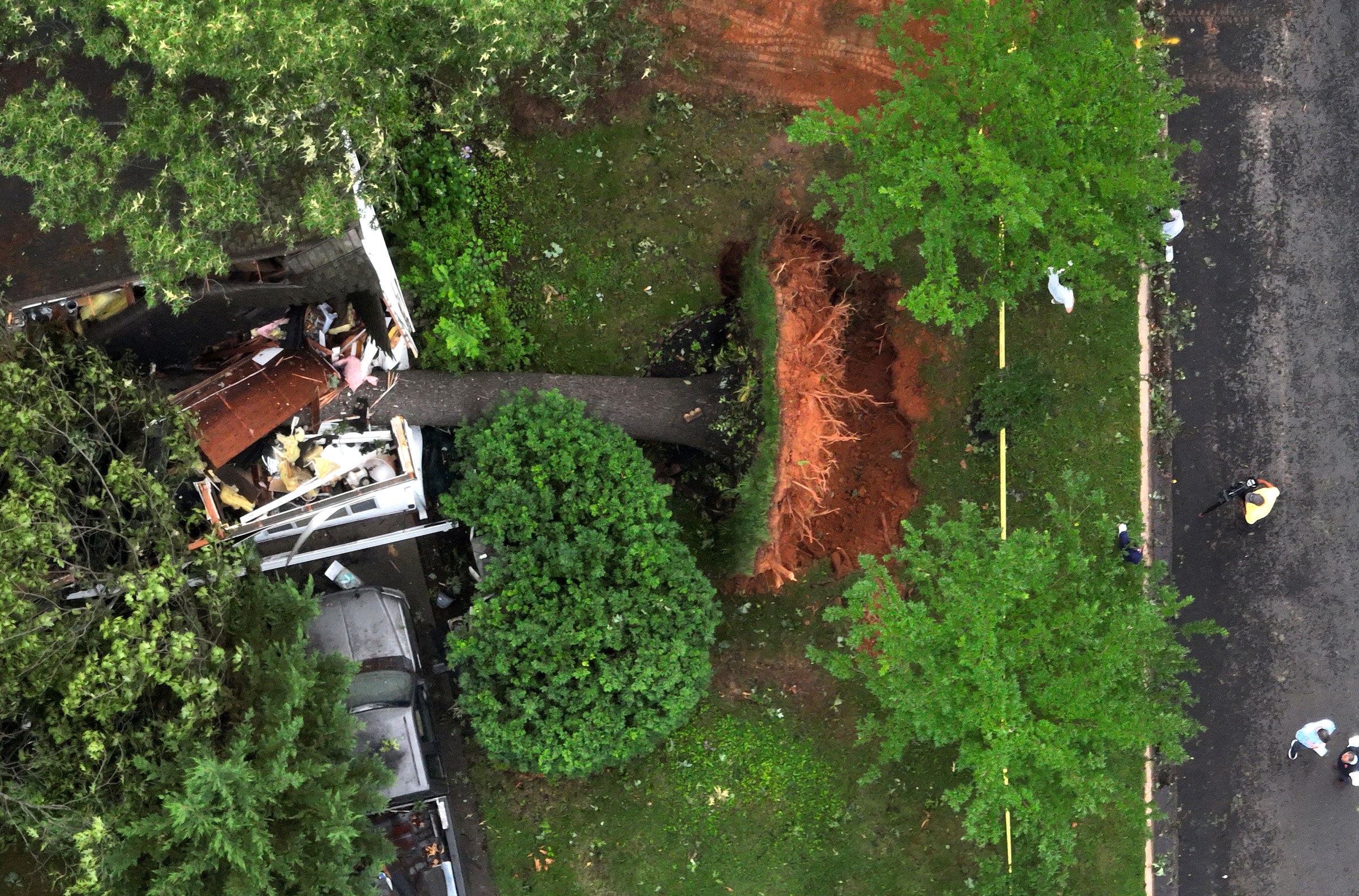 In this aerial view, a home is crushed by a fallen tree knocked down by a tornado in the Olde Towne neighborhood in Gaithersburg, Maryland. 