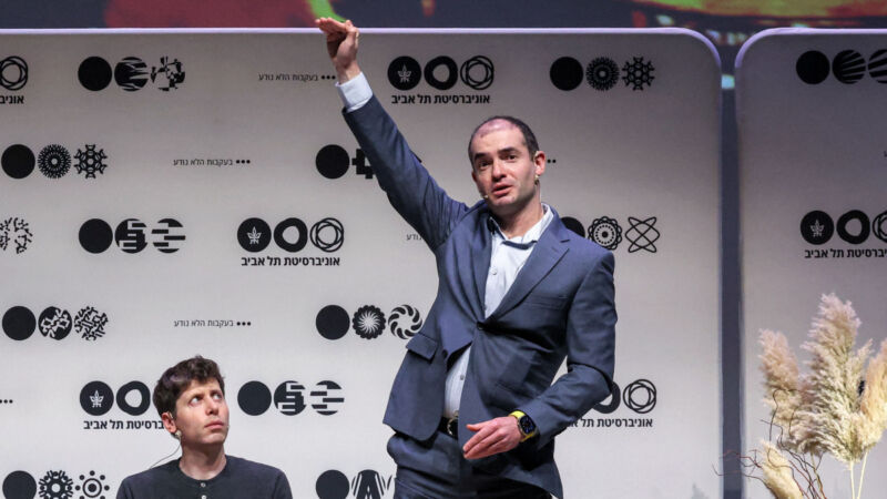 Illya Sutskever physically gestures as OpenAI CEO Sam Altman looks on at Tel Aviv University on June 5, 2023.