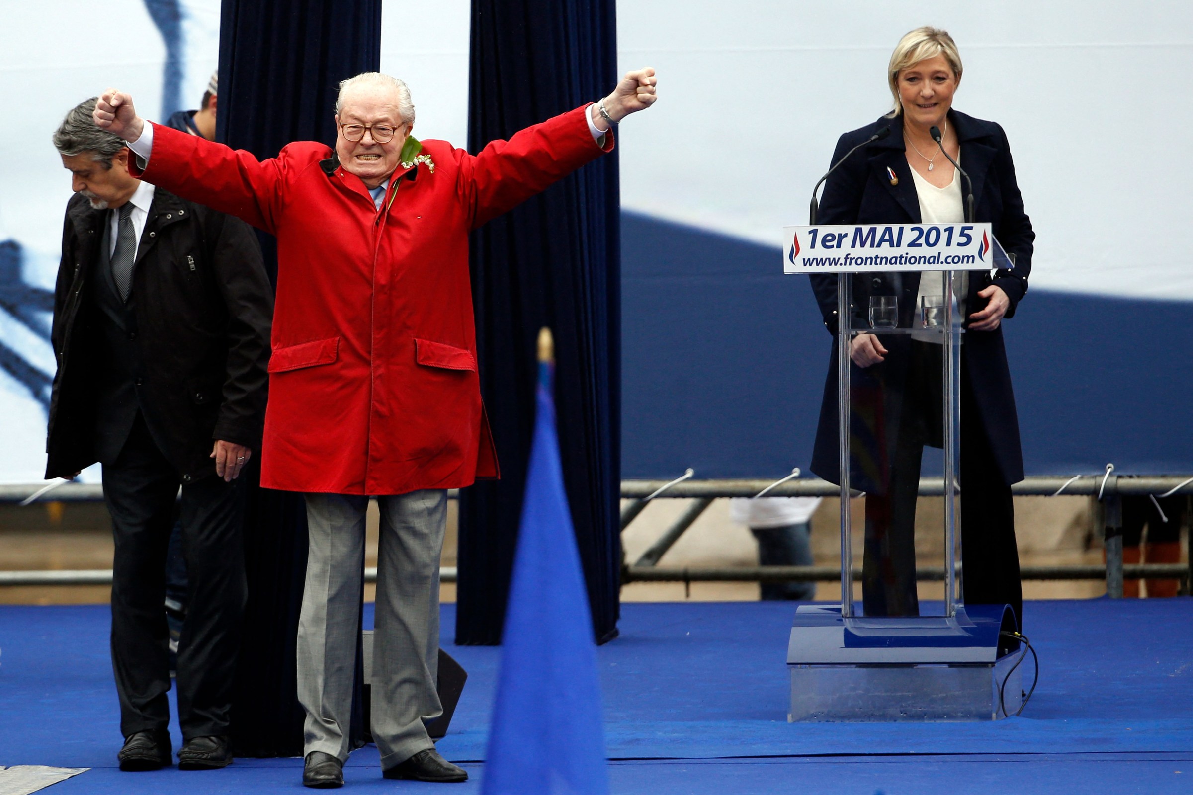 France's far-right political party Front National founder and honorary president Jean-Marie Le Pen gestures onstage as FN's president Marine Le Pen looks on, in Paris France, May 1, 2015.