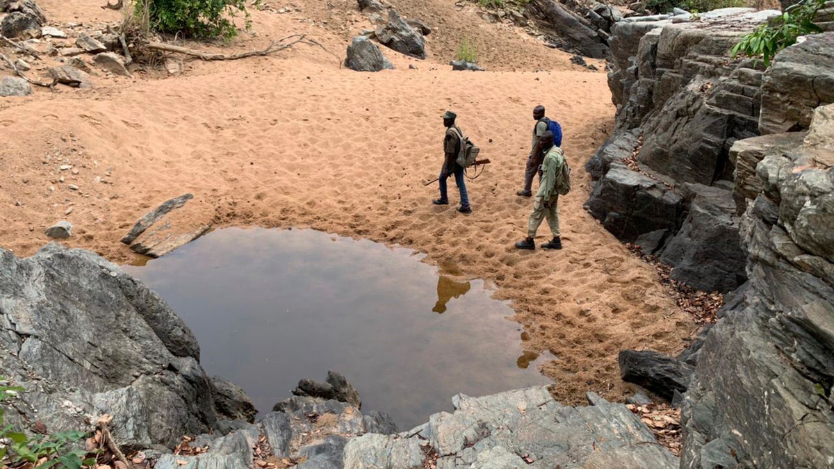 Armed rangers in green fatigues patrol at the Kainji Lake National Park in Nigeria's Niger State.