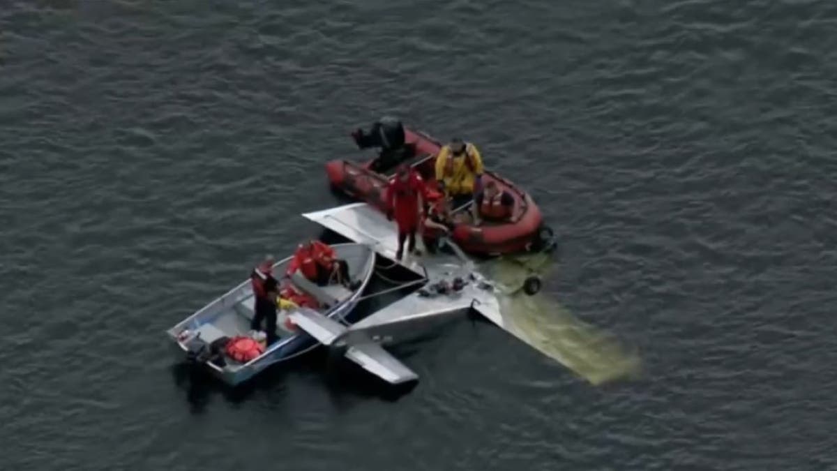 Wide aerial of first responders tending to plane