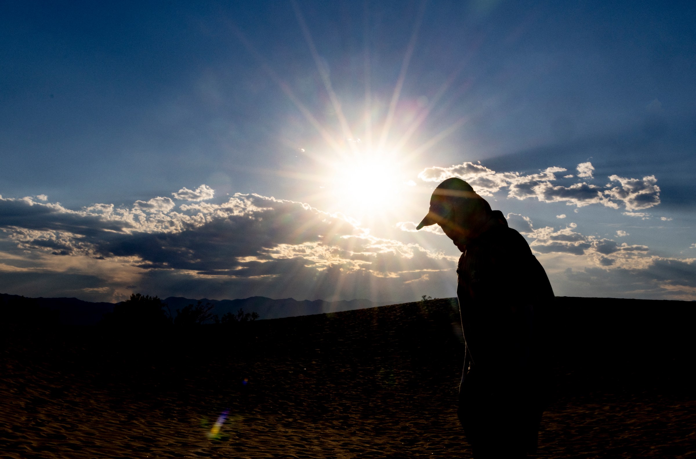 A tourist hikes in the Mesquite Flat Sand Dunes in Death Valley National Park, near Furnace Creek, during a heat wave on July 7, 2024.