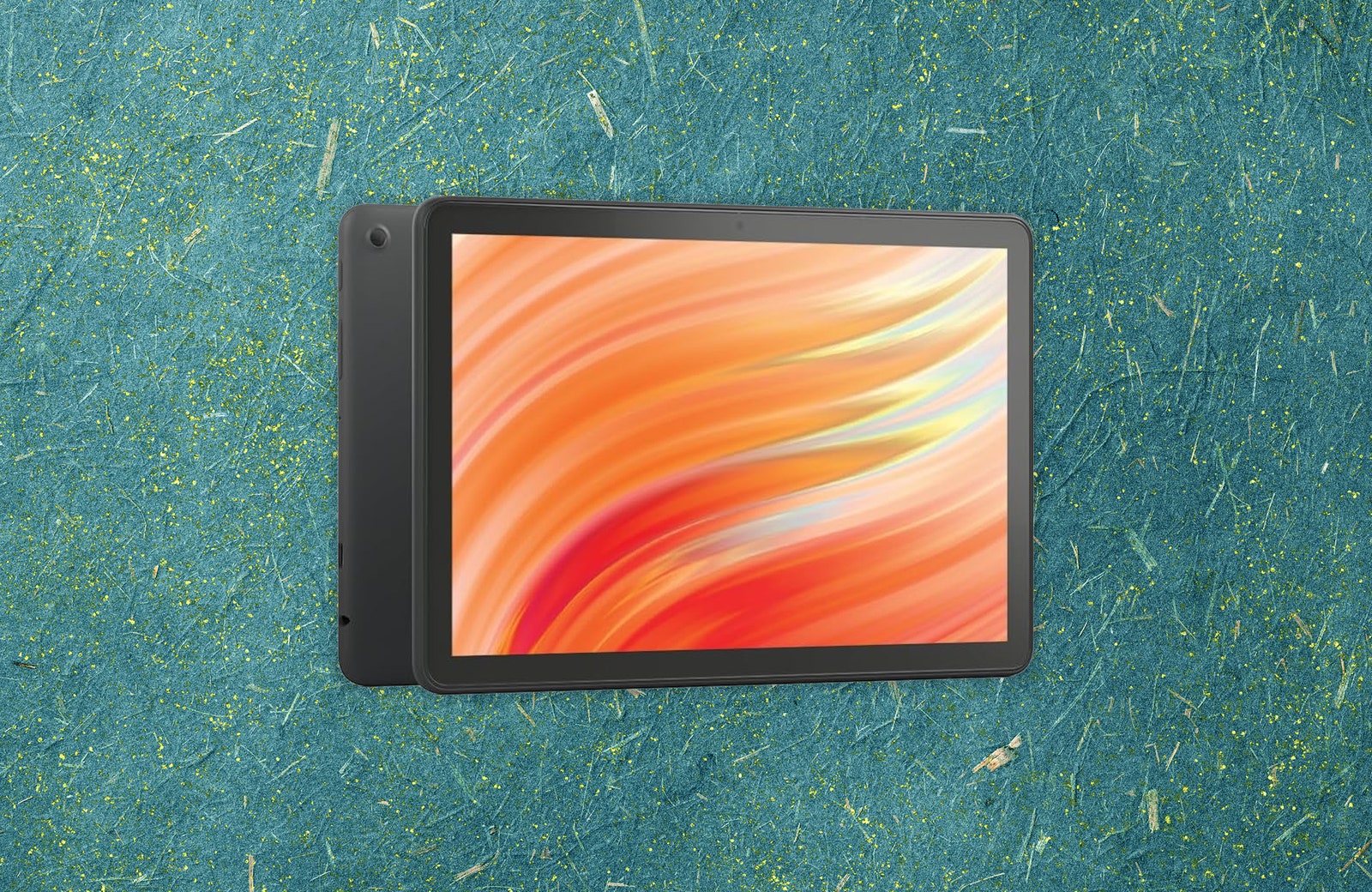 Black tablet with orange abstract art on the screen. Background green recycled paper texture.