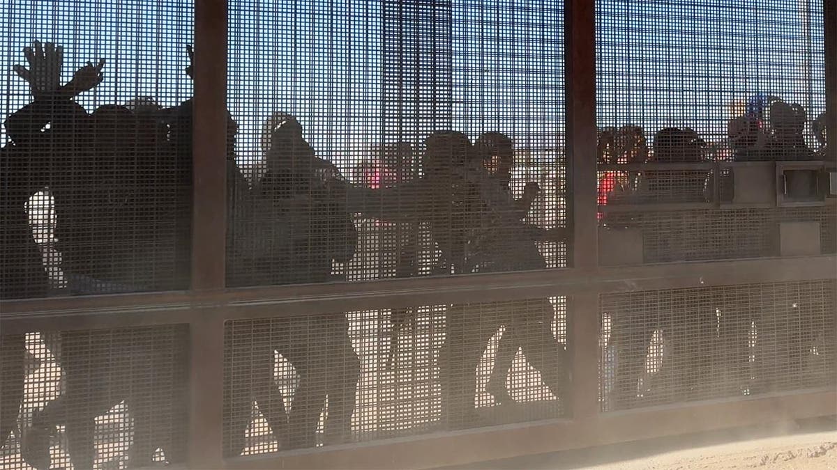 Migrants storm the gate at the border in El Paso