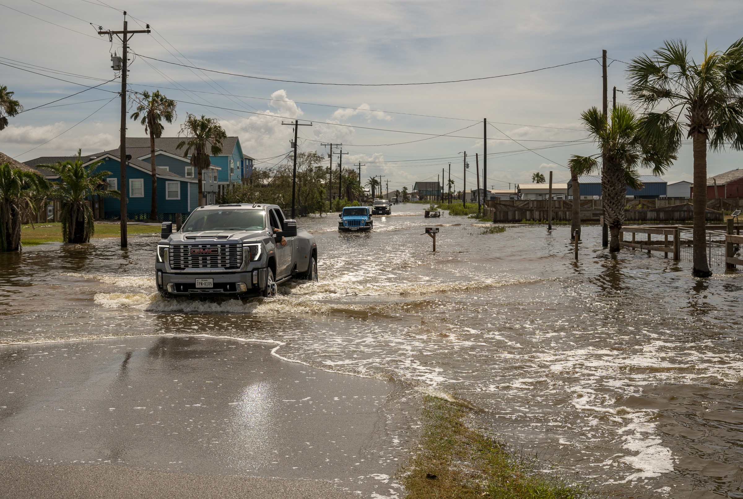 Vehicles travel through a flooded street after Hurricane Beryl made landfall in Sargent, Texas, US, on Monday, July 8, 2024. Hurricane Beryl made landfall on the Texas coast early Monday, bringing heavy rains and life-threatening storm surge after churning across the Caribbean Sea and the Gulf of Mexico. Photographer: Eddie Seal/Bloomberg via Getty Images