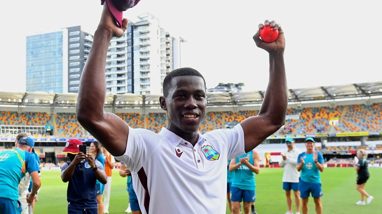 West Indies' Shamar Joseph raises the ball after taking 7 wickets in his team's defeat of Australia on the 4th day of their cricket test match in Brisbane, Sunday, Jan. 28, 2024. (Jono Searle/AAP Image via AP)