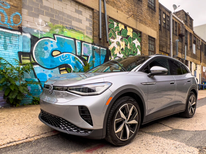 A silver VW ID.4 next to some graffiti in an alley