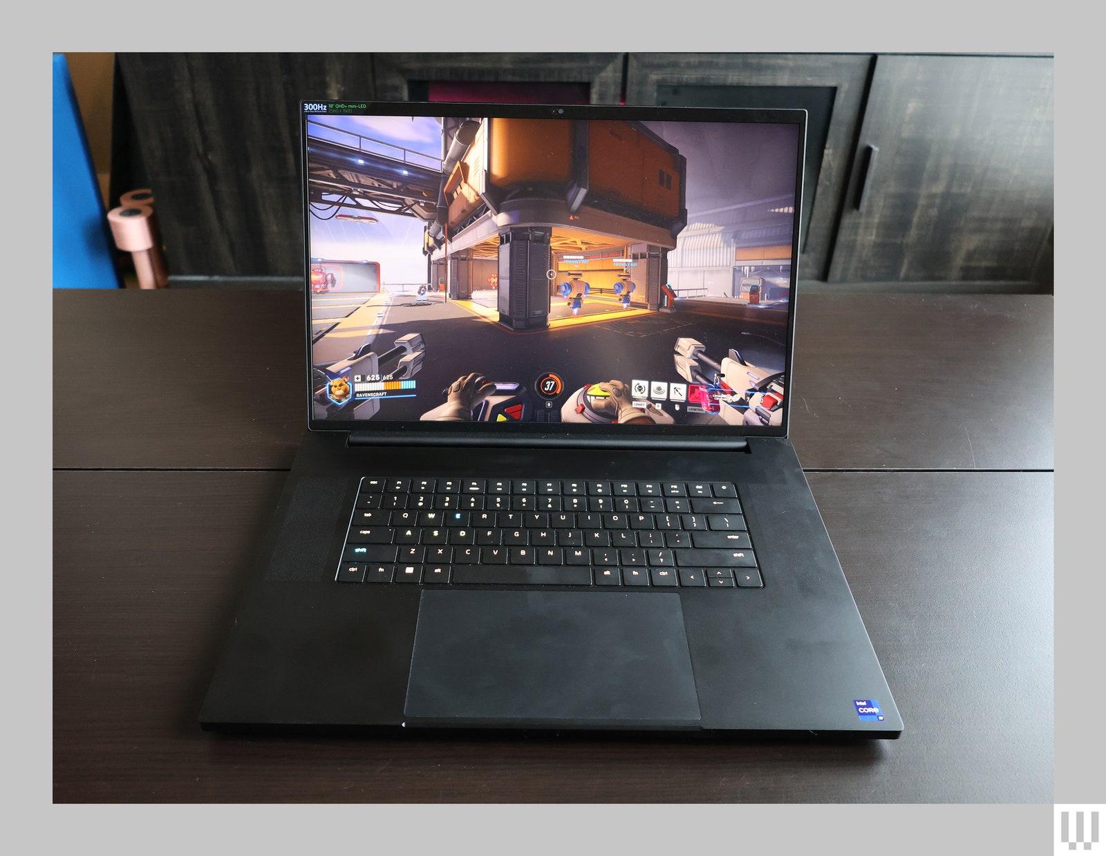 Front view of black laptop opened at 90 degrees with a firstperson perspective video game on the screen