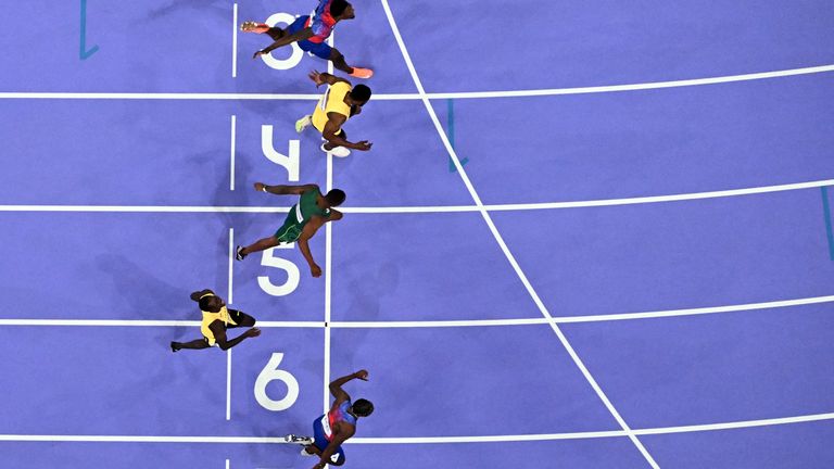 Noah Lyles (bottom) crossing the finish line in the men's 100m final 