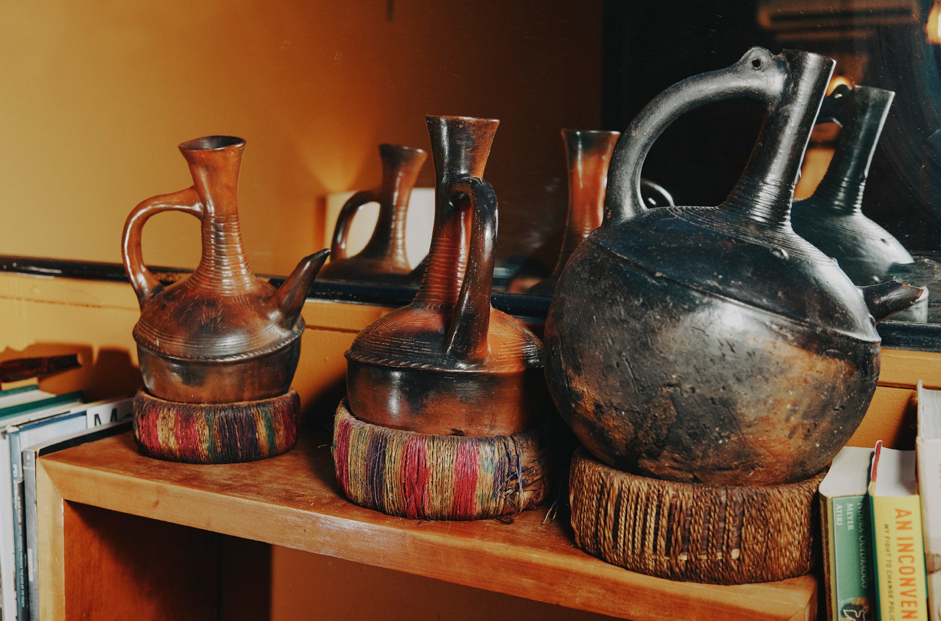 A photo of jebenas stacked on a bookcase