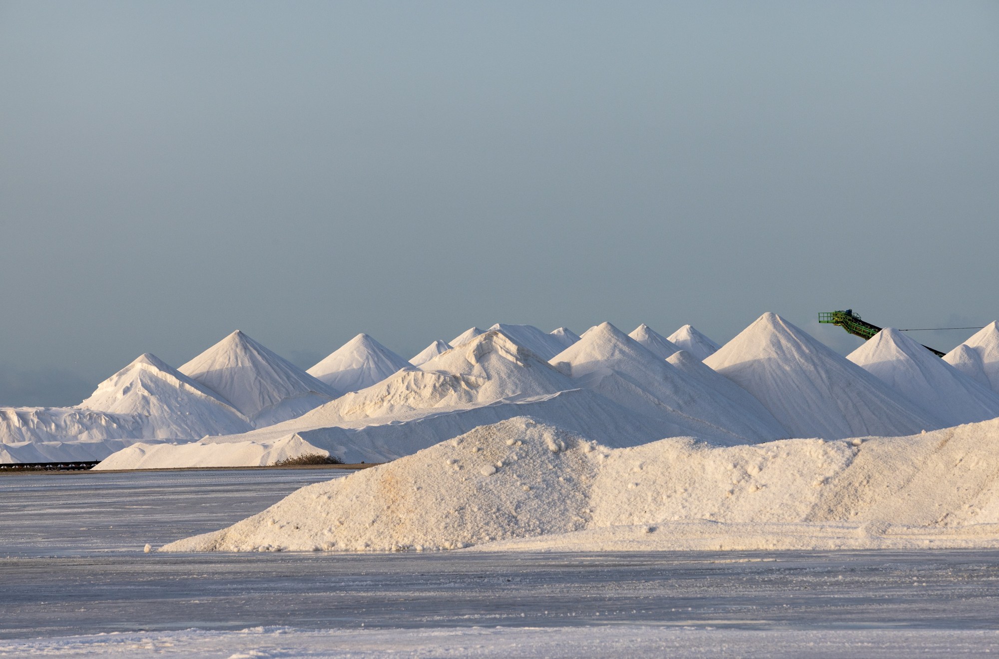 Giant mounds of salt in a greyish blue landscape