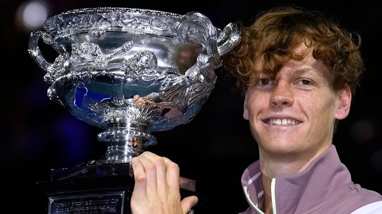 Jannik Sinner of Italy holds the Norman Brookes Challenge Cup aloft after defeating Daniil Medvedev of Russia in the men's singles final at the Australian Open tennis championships at Melbourne Park, in Melbourne, Australia, Sunday, Jan. 28, 2024. (AP Photo/Andy Wong)