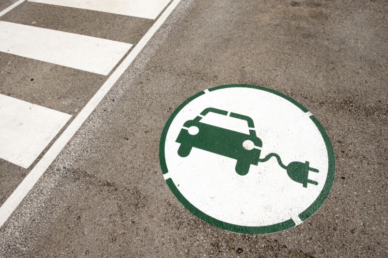 A logo of an EV painted on the ground