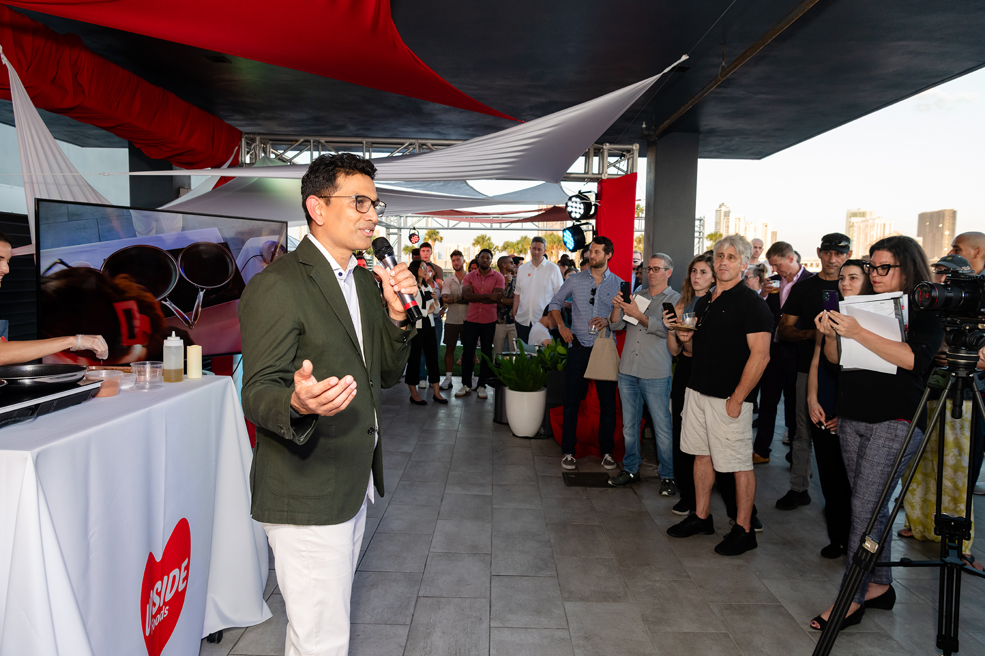 A man speaking to a crowd using a microphone.