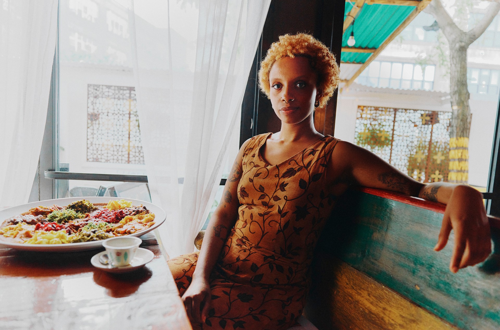 Noella Williams, a Brooklyn-based freelance writer, eats within her vegan diet at Bunna Cafe, an Ethiopian restaurant.