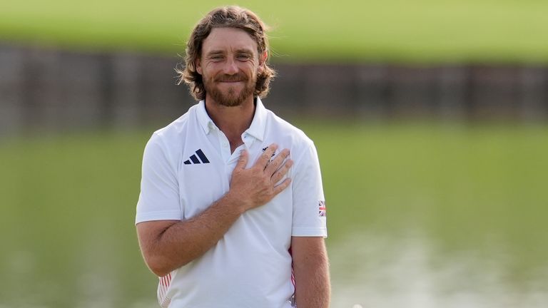 Tommy Fleetwood, of Britain, reacts to the crowd after winning the silver medal in the men's golf at the 2024 Summer Olympics, Sunday, Aug. 4, 2024, at Le Golf National in Saint-Quentin-en-Yvelines, France. Scottie Scheffler, of the United States, wins the gold medal with Tommy Fleetwood, of Britain, silver and Hideki Matsuyama, of Japan, the bronze. (AP Photo/George Walker IV)