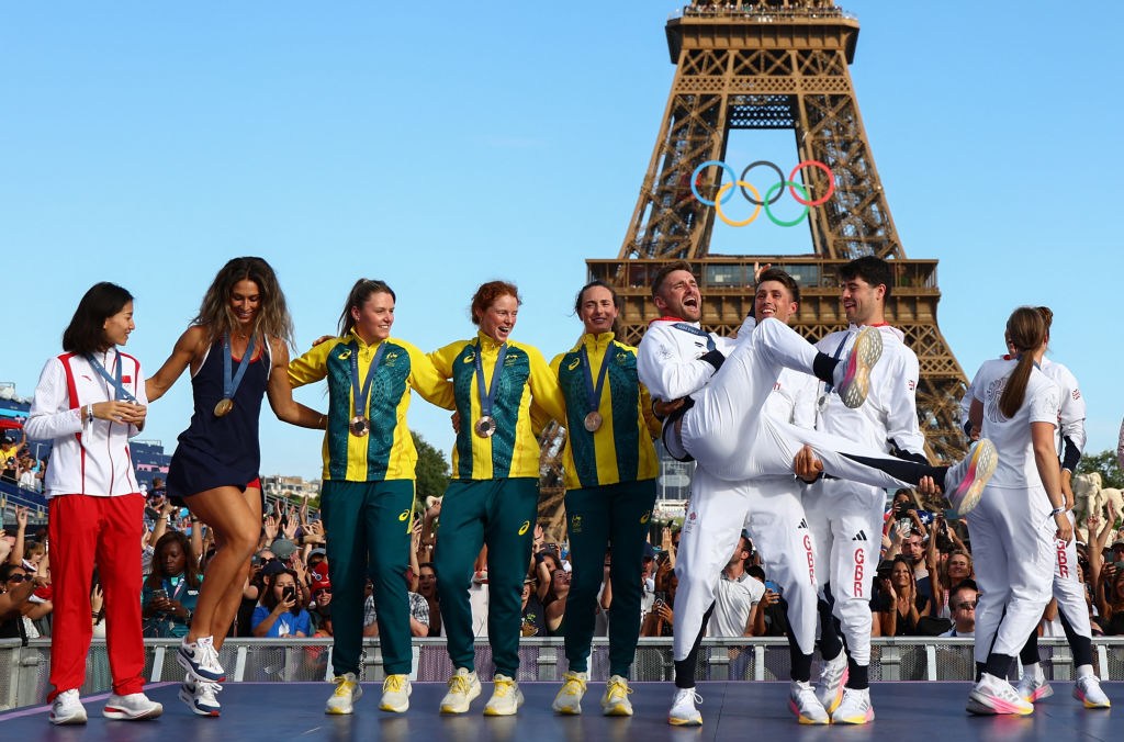 Athletes celebrate their medals in front of the Eiffel Tower