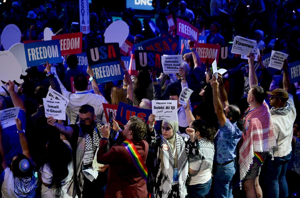 A delegate turns their back in protest during a ceremonial roll call vote during the Democratic National Convention on Tuesday. Pro-Palestinian protesters have convened in Chicago to call for an end to US aid to Israel.