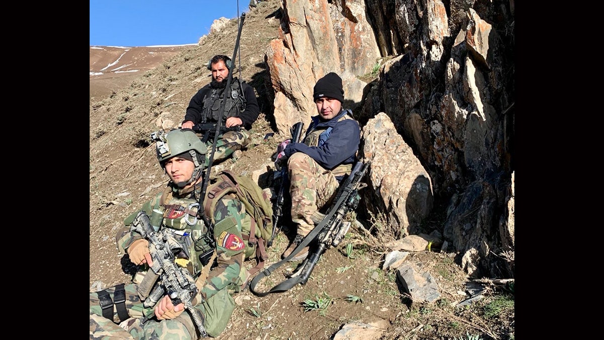 Former Afghan Lt. General Sami Sadat sits with fellow Afghan army troops amid the U.S. war in Afghanistan.