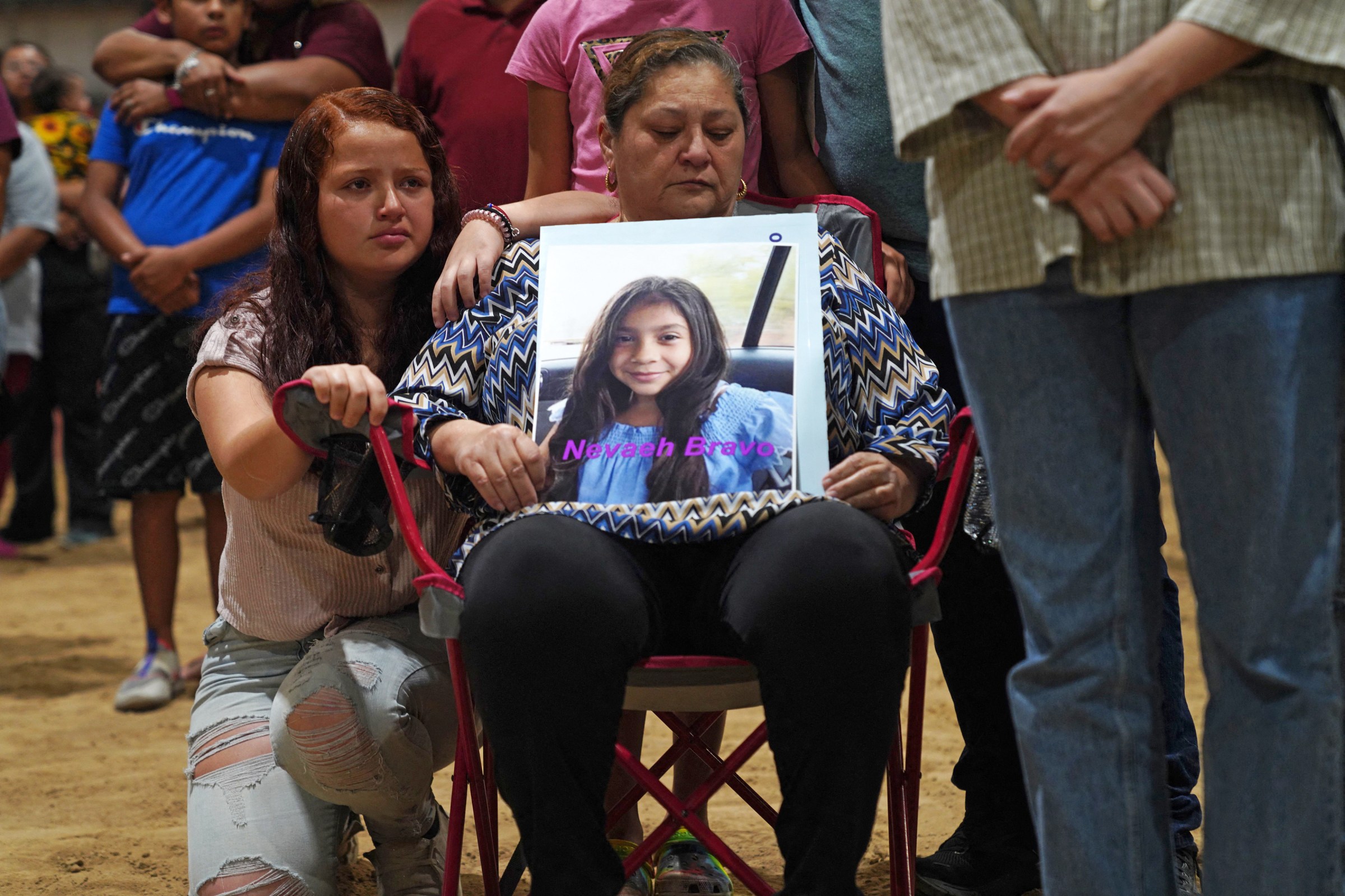 A woman holds a photo of Nevaeh Bravo, who was killed in the mass shooting at Robb Elementary School, during a vigil for the victims in Uvalde, Texas, on May 25, 2022.