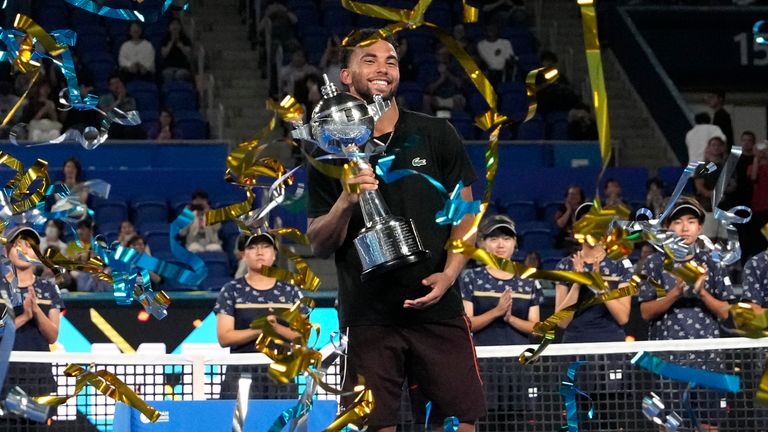 Arthur Fils of France celebrates with the trophy after defeating his compatriot Ugo Humbert in their men's singles final match at the Japan Open tennis tournament on Tuesday, Oct. 1, 2024, at Ariake Coliseum, in Tokyo, Japan. (AP Photo/Eugene Hoshiko)