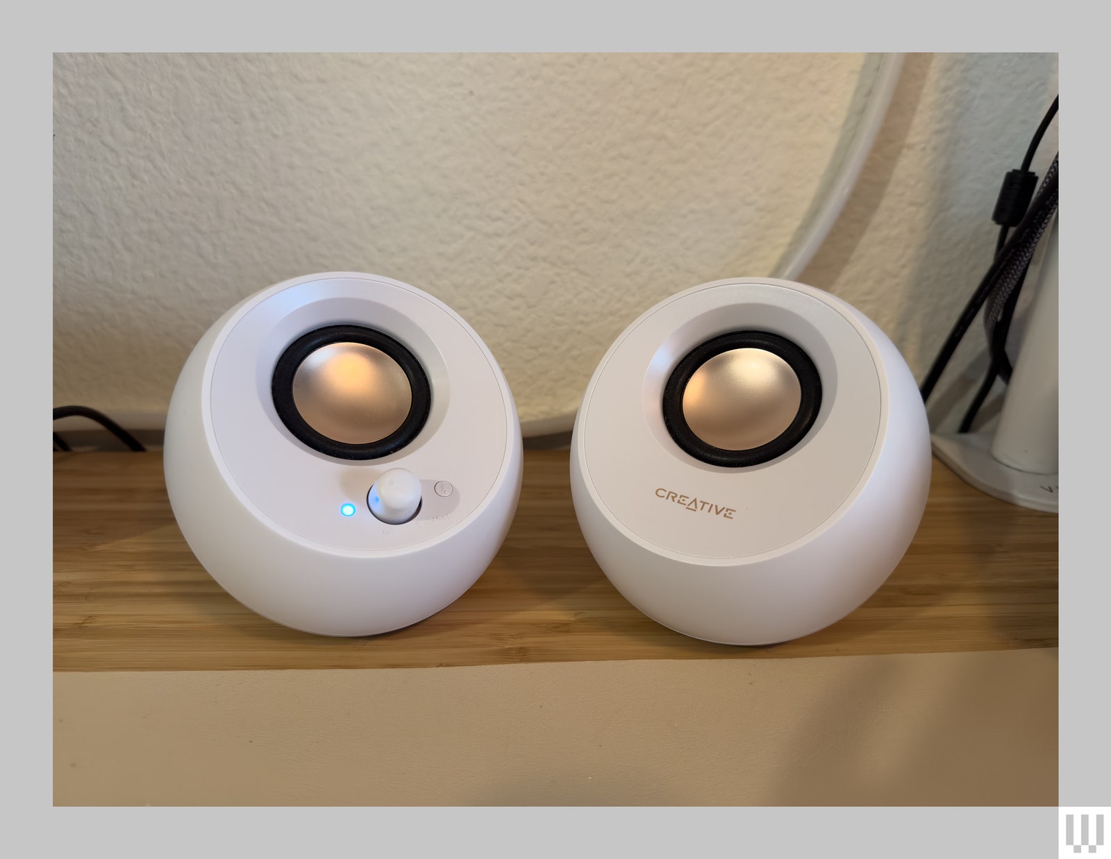 2 round white speakers with gold centers