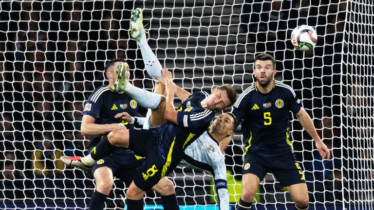 GLASGOW, SCOTLAND - OCTOBER 15: Portugal...s Cristiano Ronaldo attempts an overhead kick unbder pressure from Scotland's Billy Gilmour during a UEFA Nations League Group A1 match between Scotland and Portugal at Hampden Park, on October, 15, 2024, in Glasgow, Scotland. (Photo by Craig Williamson / SNS Group)