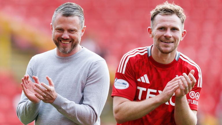 Aberdeen manager Jimmy Thelin (left) shares a joke with Nicky Devlin 