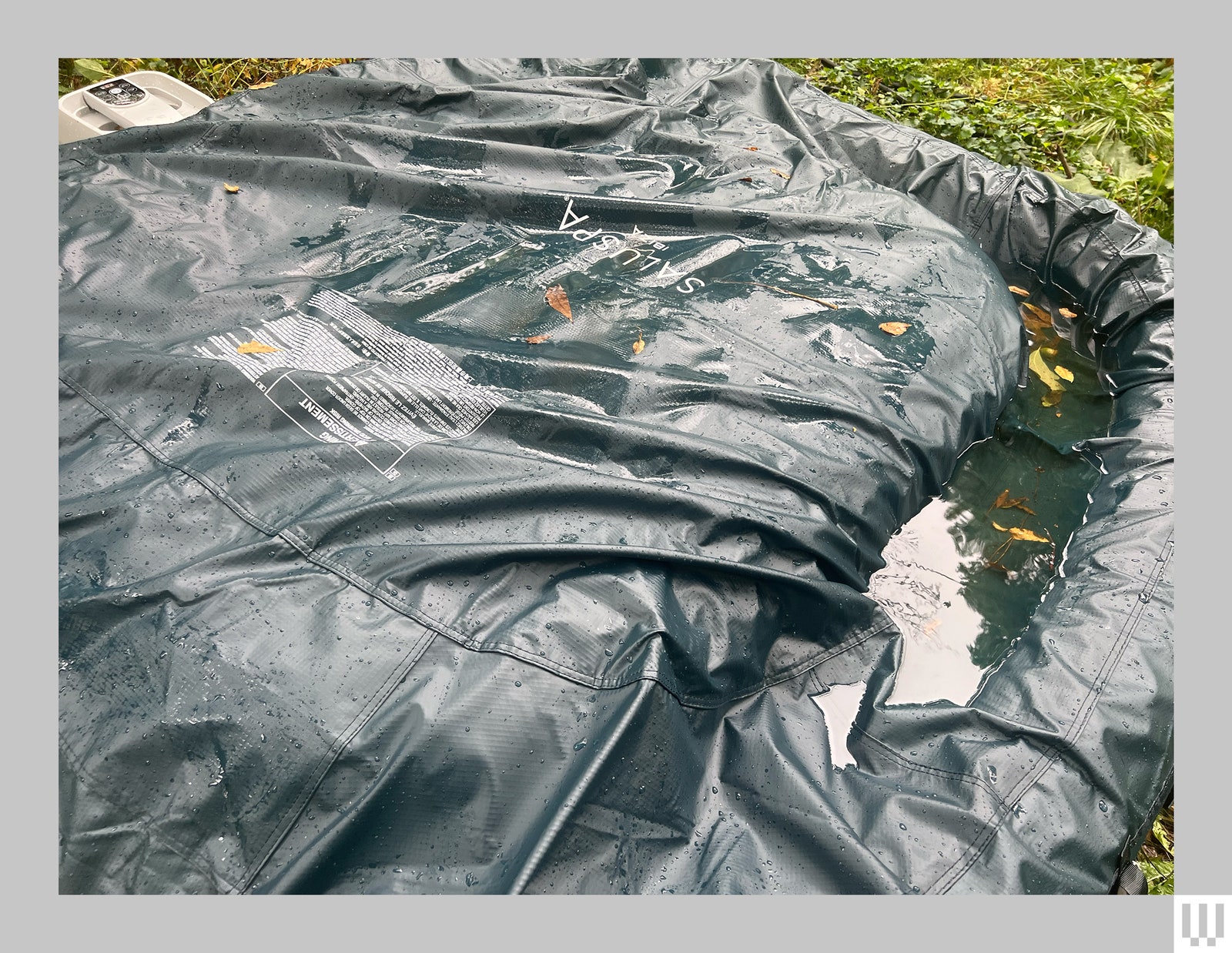 View of the SaluSpa Ibiza Inflatable Hot Tub covered with thick tarp material some areas dipping under the weight of...