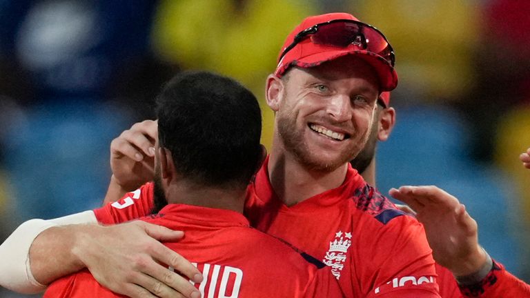 England's captain Jos Buttler, center, celebrates with Adil Rashid taking the catch to dismiss West Indies' Sherfane Rutherford during the first T20 cricket match at Kensington Oval in Bridgetown, Barbados, Saturday, Nov. 9, 2024. (AP Photo/Ricardo Mazalan)