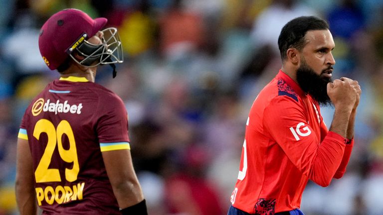 England's Adil Rashid celebrates taking the wicket of West Indies' captain Rovman Powell during the first T20 cricket match at Kensington Oval in Bridgetown, Barbados, Saturday, Nov. 9, 2024. (AP Photo/Ricardo Mazalan)