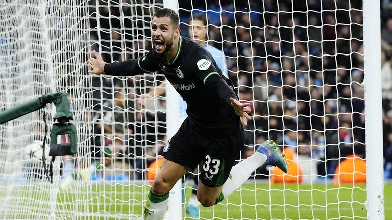 Hancko wheels away in celebration after his goal