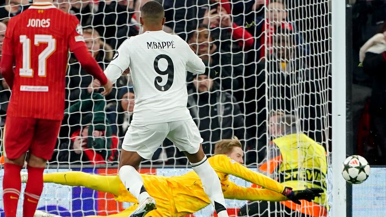 Liverpool goalkeeper Caoimhin Kelleher (rear) saves a penalty from Real Madrid's Kylian Mbappe