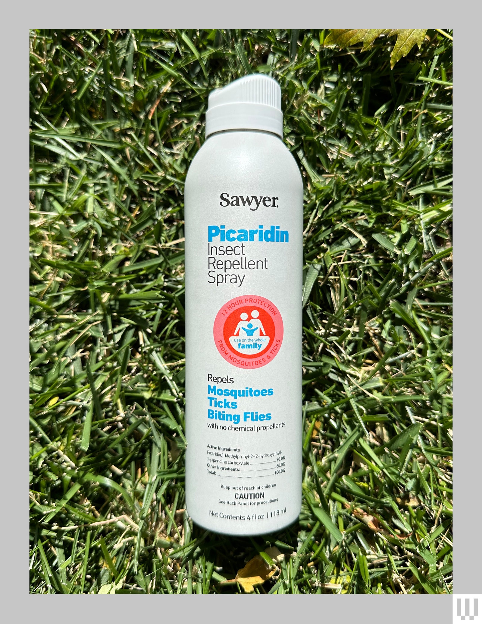 Sawyer Picaridin Insect Repellent a white spray can with blue text laying in grass