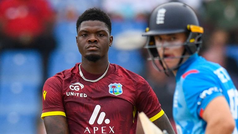 Alzarri Joseph (L) of West Indies watches as Jacob Bethell (R) of England gets 4 runs during the 1st ODI match between West Indies and England at Vivian Richards Cricket Stadium in North Sound, Antigua and Barbuda, on October 31, 2024. (Photo by Randy Brooks / AFP)