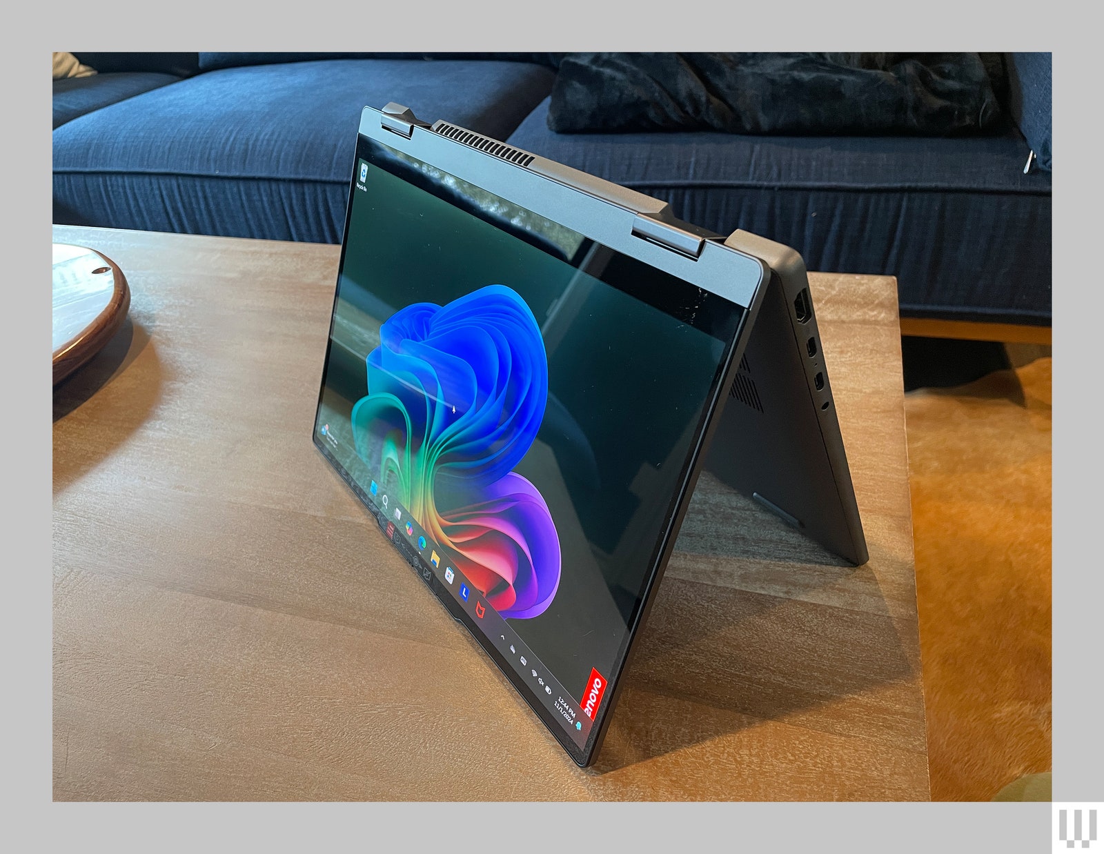 Lenovo Idea Pad 5X twoinone in the folded upright position with the screen showing abstract art